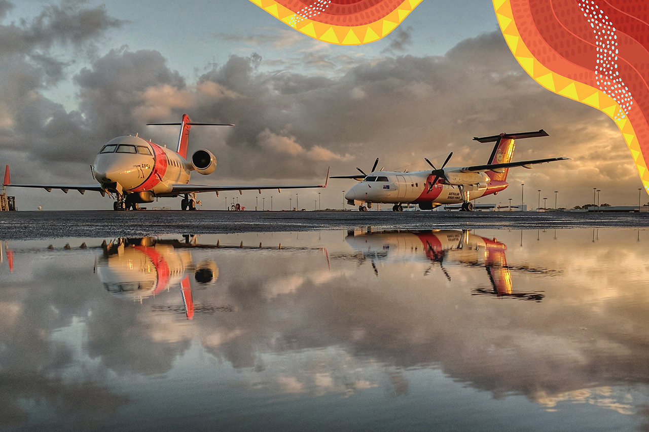 AMSA rescue aircraft on a tarmac with indigenous artwork in the top right hand corner