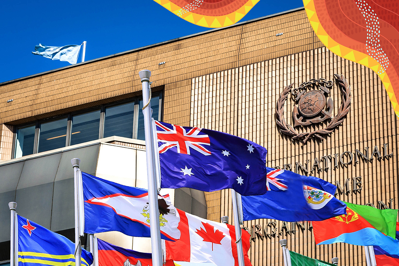 Australian flag in the middle of a group of flags in front of a building