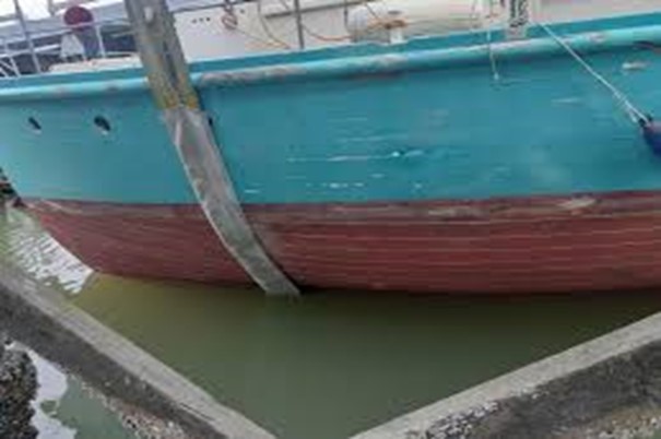  A boat lifted out of the water to help examine the hull below the waterline