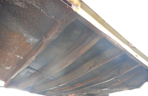 A photo of visible structural damage to a container carrying 12mm rebar coils.