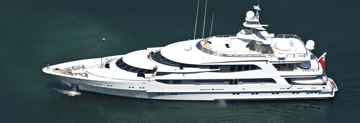 A top-down photographed of a superyacht travelling on clear waters