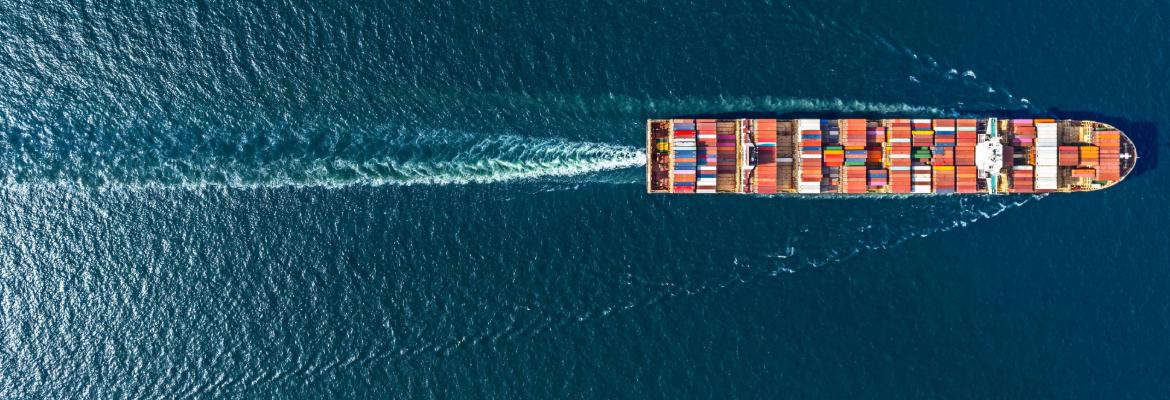 Aerial top-down view of a container ship sailing in the ocean